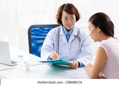 Female Doctor Explaining Medical Tests To The Young Woman