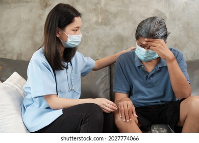 Female Doctor With Face Mask Checking Health Of Asian Elderly Male Patient At Home As A Medical Service For Visiting Sick Older People After Retirement And Caregiver From Professional