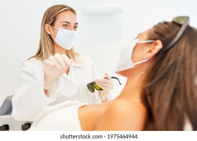 Female Doctor With Face Mask During A Treatment For A Young Woman In The Beauty Clinic