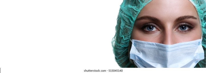 Female Doctor Face Wearing Protective Mask And Green Surgeon Cap Closeup Isolated On White Background. Save Patient Life, Copy Space Banner, Laboratory, 911, Medic Help Concept. Letterbox View