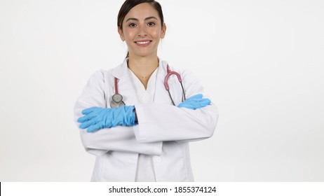 Female doctor folding arms while smiling moving in towards them on white background.