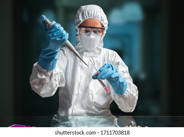 Female doctor in full protection suit doing coronavirus testing in the laboratory - Powered by Shutterstock