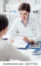 Female Doctor Giving A Consultation To A Patient And Explaining Medical Informations And Diagnosis