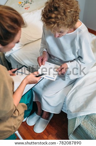 Doctor giving a prescription to senior patient