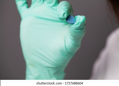 Female Doctor In Gloves Holds Pills For Men's Sexual Health