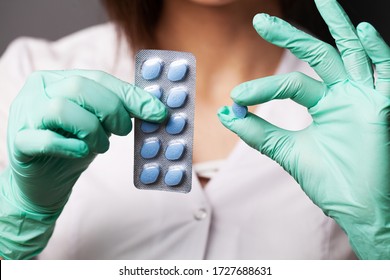 Female Doctor In Gloves Holds Pills For Men's Sexual Health