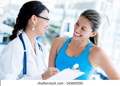 Female Doctor At The Gym With A Patient