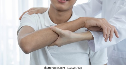 Female doctor hand doing physical therapy By extending the shoulder of a male patient. - Powered by Shutterstock