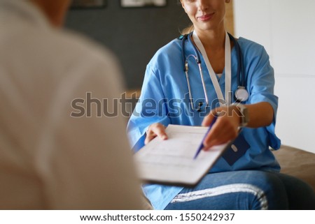 Similar – Doctor giving a prescription to senior patient