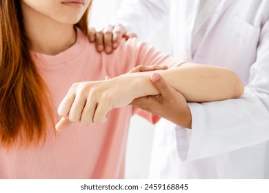 Female doctor hand rehab physical therapy by extending the pain shoulder of a patient. treatment with stretch exercises. - Powered by Shutterstock