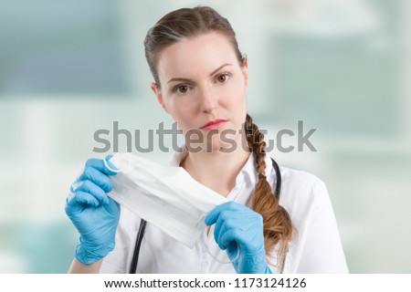 female doctor is handling a medical face mask for hygienic reasons