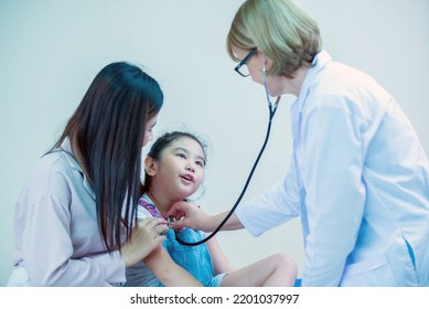 Female Doctor Health Check Up Girl In Hospital Examination Room