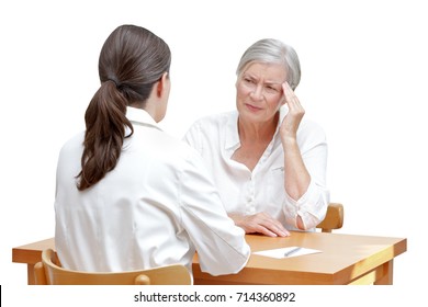 Female Doctor With Her Senior Patient With Sleeping Trouble, Suffering Of Splitting Headache Or Migraine, Isolated On White Background