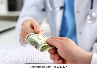 Female Doctor Hold In Hands Bunch Of Hundred Dollars Banknotes Take Or Give Them. Prestige And High Paid Job, Encash Treatment, Illegal Drug Fraud, Anonymous Visitor, Private Visit, Reform Concept