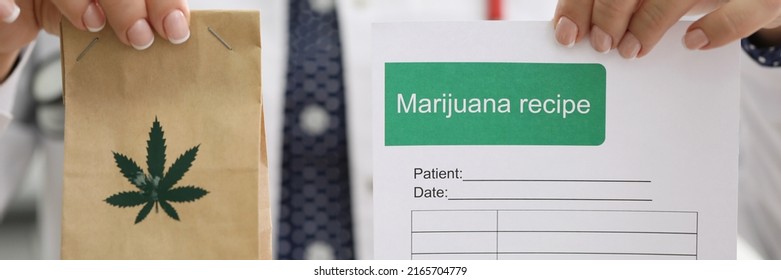 Female Doctor Holding Marijuana Recipe In One Hand And Package With Hemp In Another