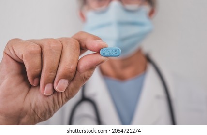 Female Doctor Holding The New Covid Antiviral Pill Who Can Halve Risk Of Hospitalisation. This Pill May Cut Numbers Of People In Hospital About A Half