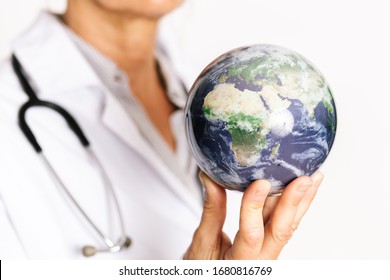 female doctor holding planet earth on her fingertips. Showing Africa map - Shutterstock ID 1680816769