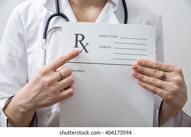 Female Doctor Holding Rx Paper In Hand