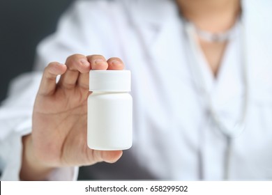 Female Doctor Holding And Showing A Medicine Bottle