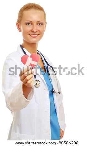A female doctor holding a symbol of a heart which is repaired