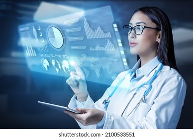 Female doctor holding a tablet computer and touching medical graphs on virtual screen. Medical innovative technology and network connection.