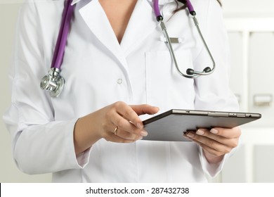 Female Doctor Holding Tablet PC. Doctor's hands close-up. Medical service and health care concept.