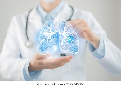 Female doctor holding virtual Lungs in hand. Handrawn human organ, copy space on right side, raw photo colors. Healthcare hospital service concept stock photo - Shutterstock ID 2029745360