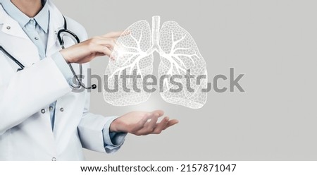 Female doctor holding virtual Lungs in hand. Handrawn human organ, copy space on right side, grey hdr color. Healthcare  scientific technologies concept stock photo