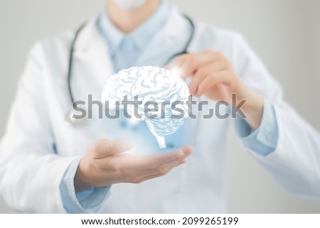 Female doctor holding virtual volumetric drawing of  Brain in hand. Handrawn human organ, copy space on right side, raw photo colors. Healthcare hospital service concept stock photo