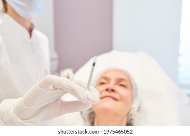 Female Doctor Holds Syringe With Hyaluronic Acid For Wrinkle Reduction In The Beauty Clinic