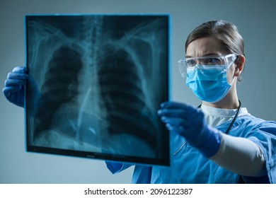 Female Doctor In Hospital Holding Patient X-ray Film,radiologist Studying Radiography Result,radiology Specialist Interpreting COVID-19 Patient Chest Scan On Asthma,lung Disease Or Bone Cancer Illness