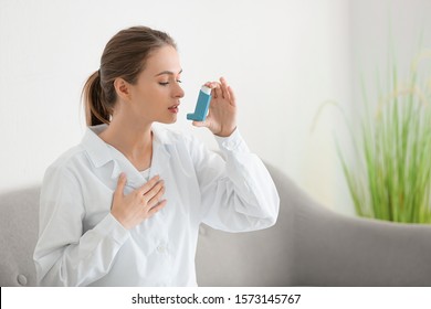 Female Doctor With Inhaler Having Asthma Attack In Clinic