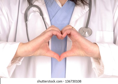 Female Doctor Isolated In White Doing Heart Shape With Hands