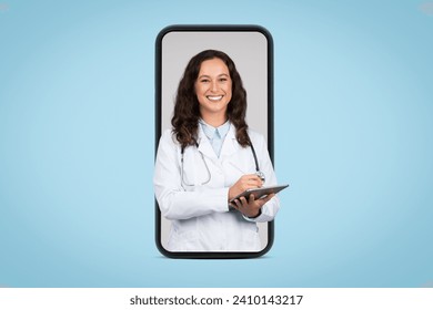 Female doctor in lab coat, holding digital tablet, displayed on giant smartphone screen, representing telemedicine or online medical consultation, blue background - Powered by Shutterstock