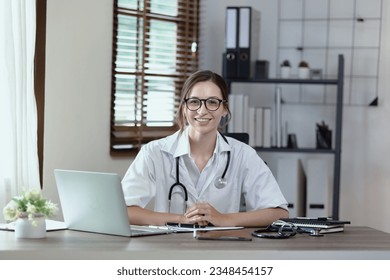 female doctor with laptop consulting patient online by computer video call conversation in her hospital office, Healthcare and medical concept. - Powered by Shutterstock