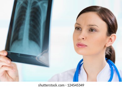 Female Doctor Looking At A Lungs Or Torso Xray, Fluorography