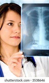 Female Doctor Looking At A Lungs Or Torso Xray