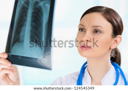 Female doctor looking at a lungs or torso xray, fluorography