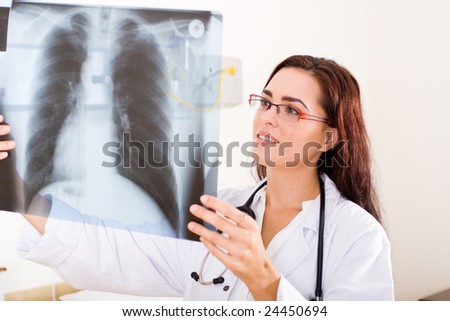 female doctor looking at a lungs or torso xray