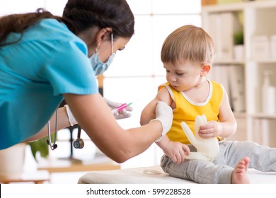 Female doctor makes a vaccination to a child