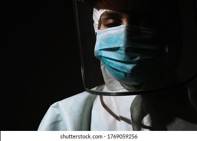 Female Doctor With Mask And Face Shield Closed Eyes Due To Coronavirus Covid-19 Pandemic