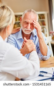 Female doctor or nurse consoles senior patient with depression or dementia - Shutterstock ID 1531451165