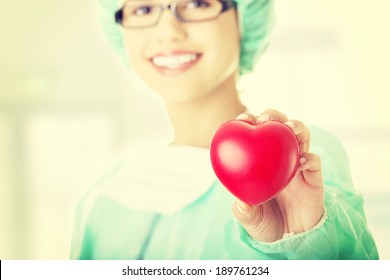 Female Doctor Or Nurse Holding Heart Shaped Toy