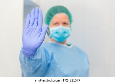 Female Doctor Or Nurse Making A Hand Signal To Stop The Crisis Or Illness, Symbol Of Denial And Concept Of Stopping In Health.