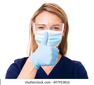 Female Doctor Nurse Practitioner Dentist Dental Hygienist In PPE Eye Protection And Face Mask Giving Gloved Thumbs Up Isolated On White Background
