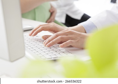 Female Doctor Or Nurse Typing On Laptop Keyboard