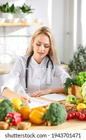 Female Doctor Nutritionist Writing Case History In Officem Dietitian Prescribing Recipe