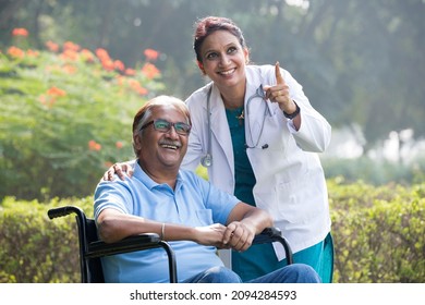 Female doctor with old man in wheelchair admiring view at park
 - Shutterstock ID 2094284593