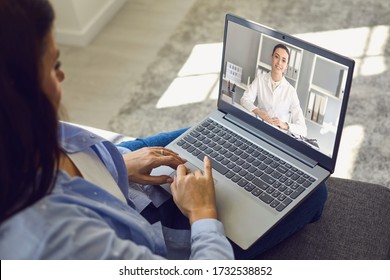 Female doctor online. A woman using a laptop listens to a consultation diagnosis analysis doctor video chat call video conference.