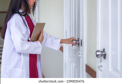 Female Doctor Opening The Door In The Patient Room In Hospital